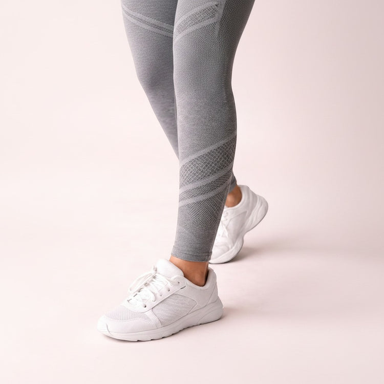 Cellu-reducing grey textured leggings with a diamond pattern detail on the calf, worn with white sneakers.
